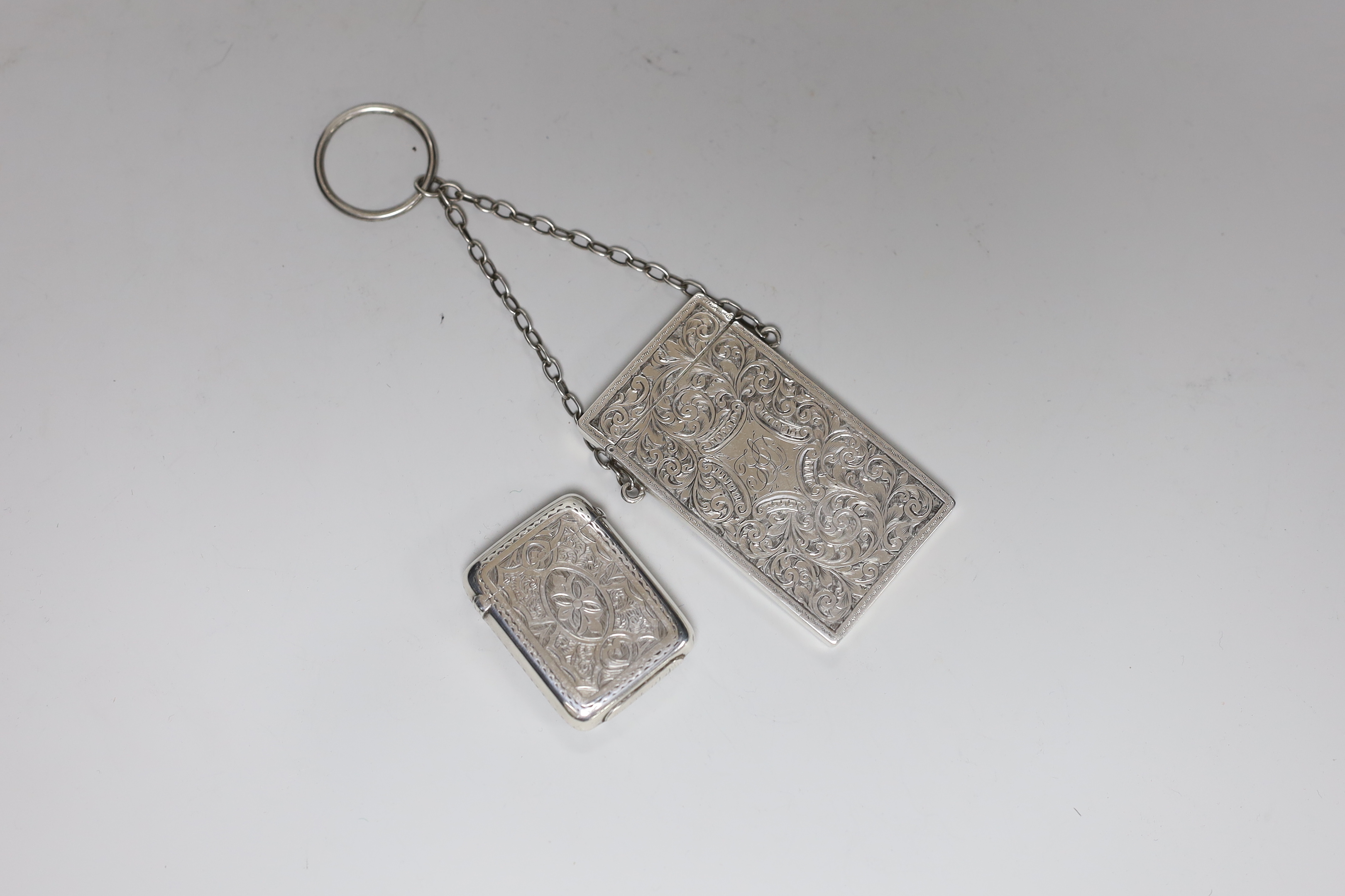 A late Victorian chased silver card case, S. Blanckensee & Son Ltd, Birmingham, 1886, 76mm and a Victorian silver vesta case.